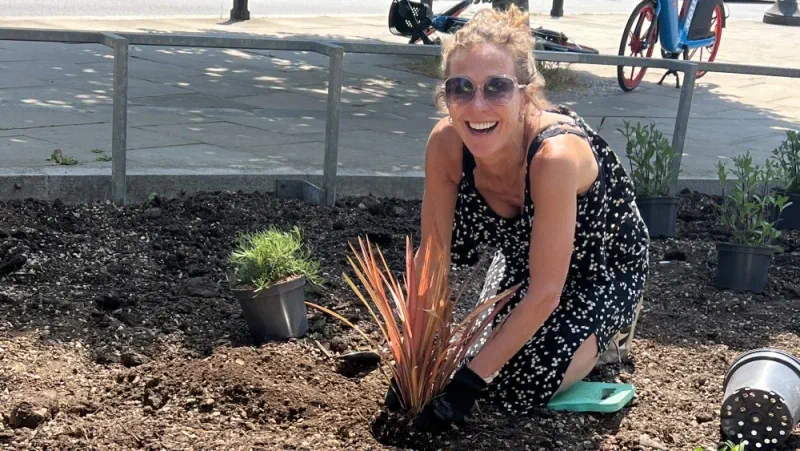female employee from International SOS planting