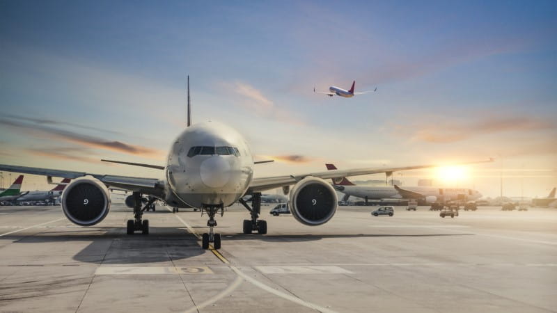 front view of airplane in airport and airplane taking off