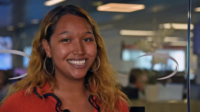 woman employee smiling at the camera in office