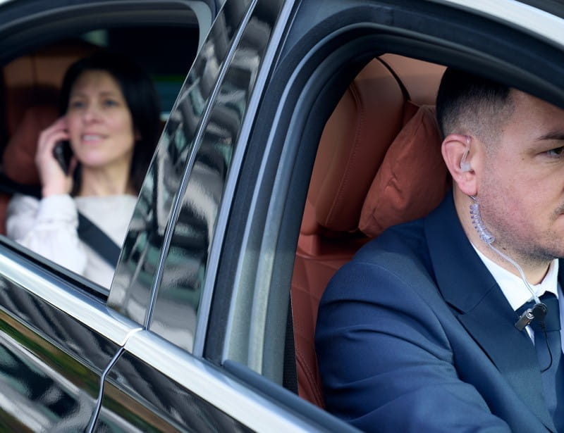 executive female being transported in secured vehicle