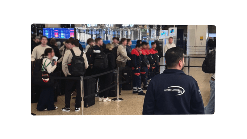 international sos staff next to travellers during an evacuation from the Middle East
